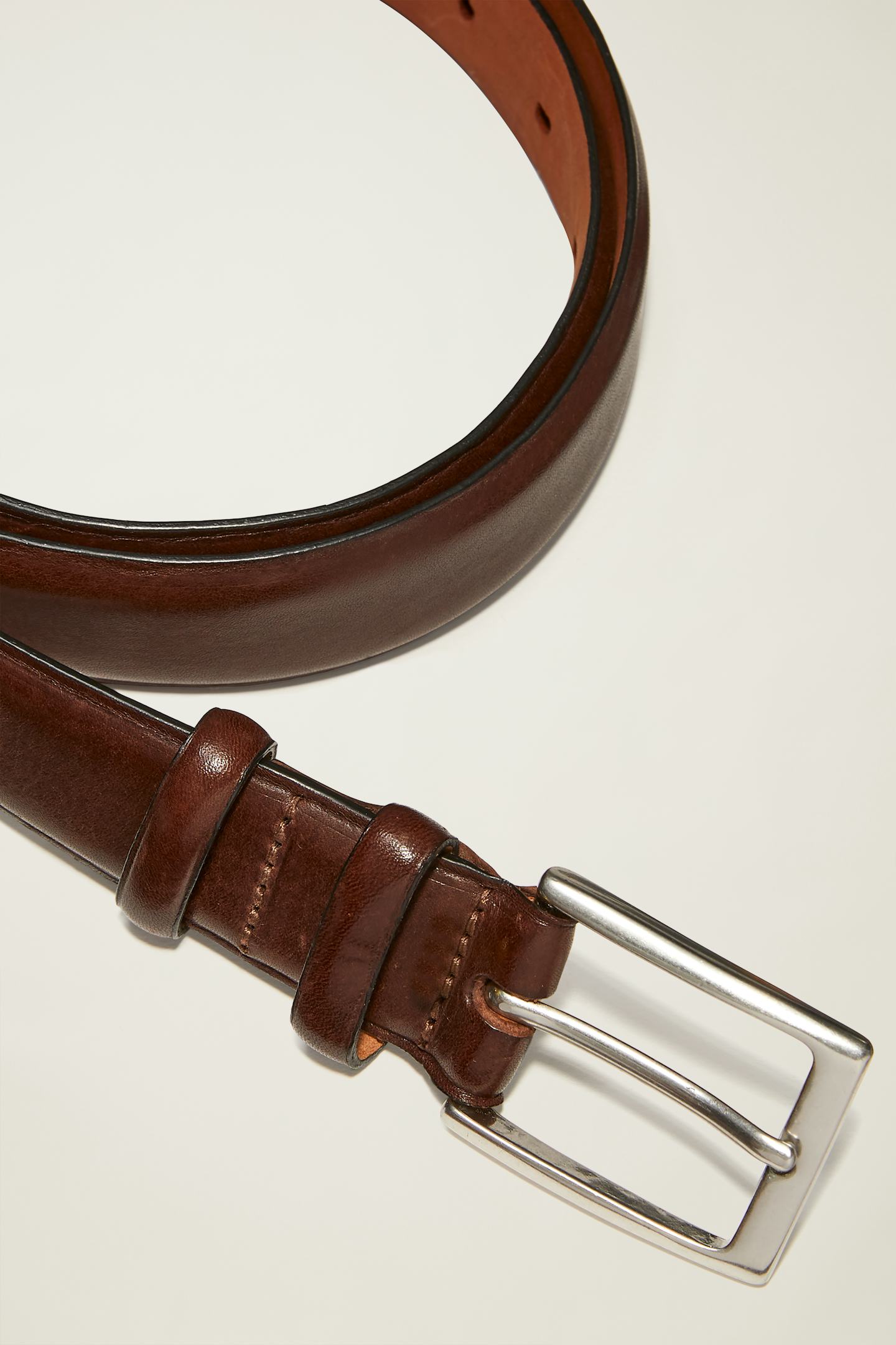 Dark brown leather dress belt with silver buckle and two loops
