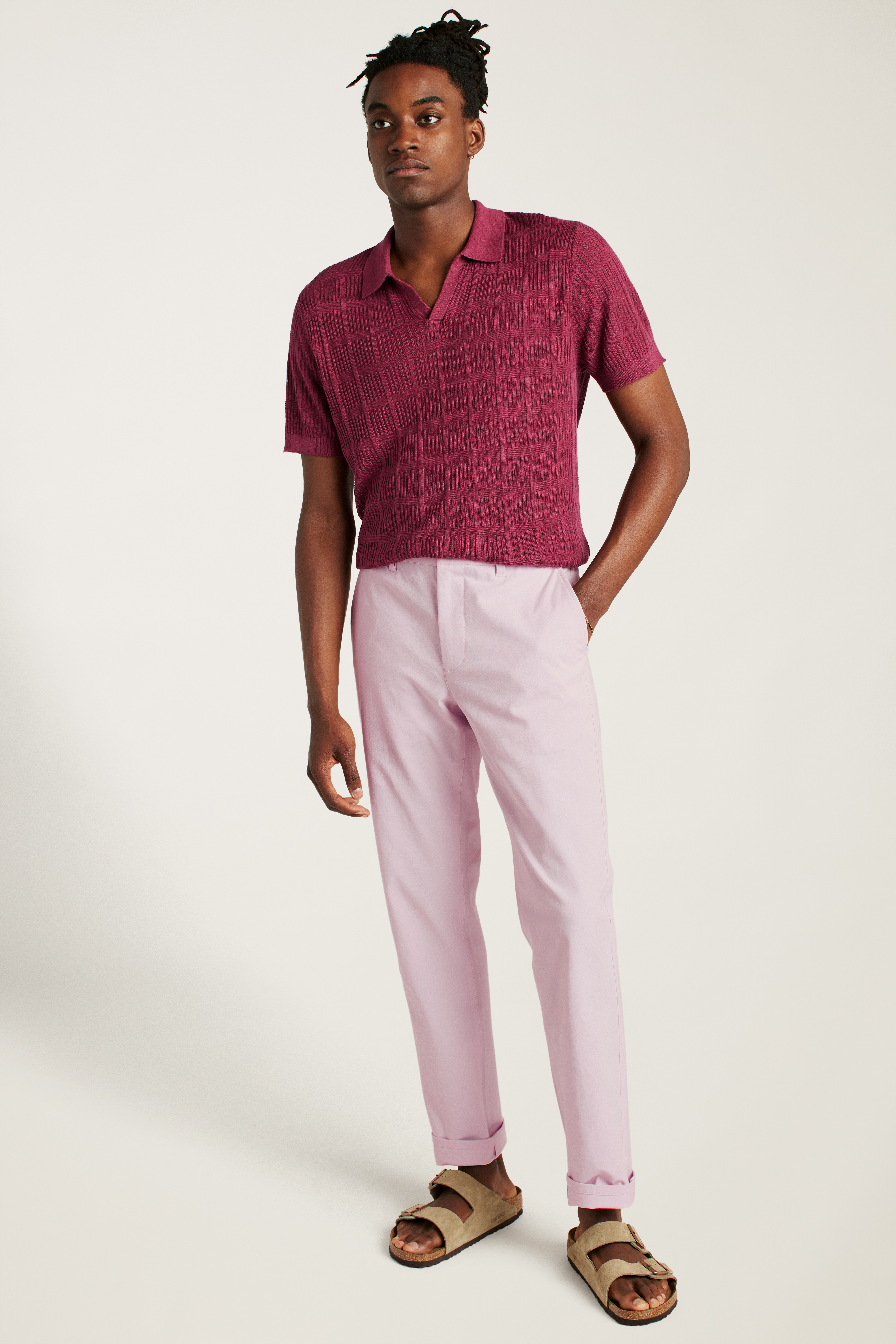 A man wearing pink pants and a red polo shirt