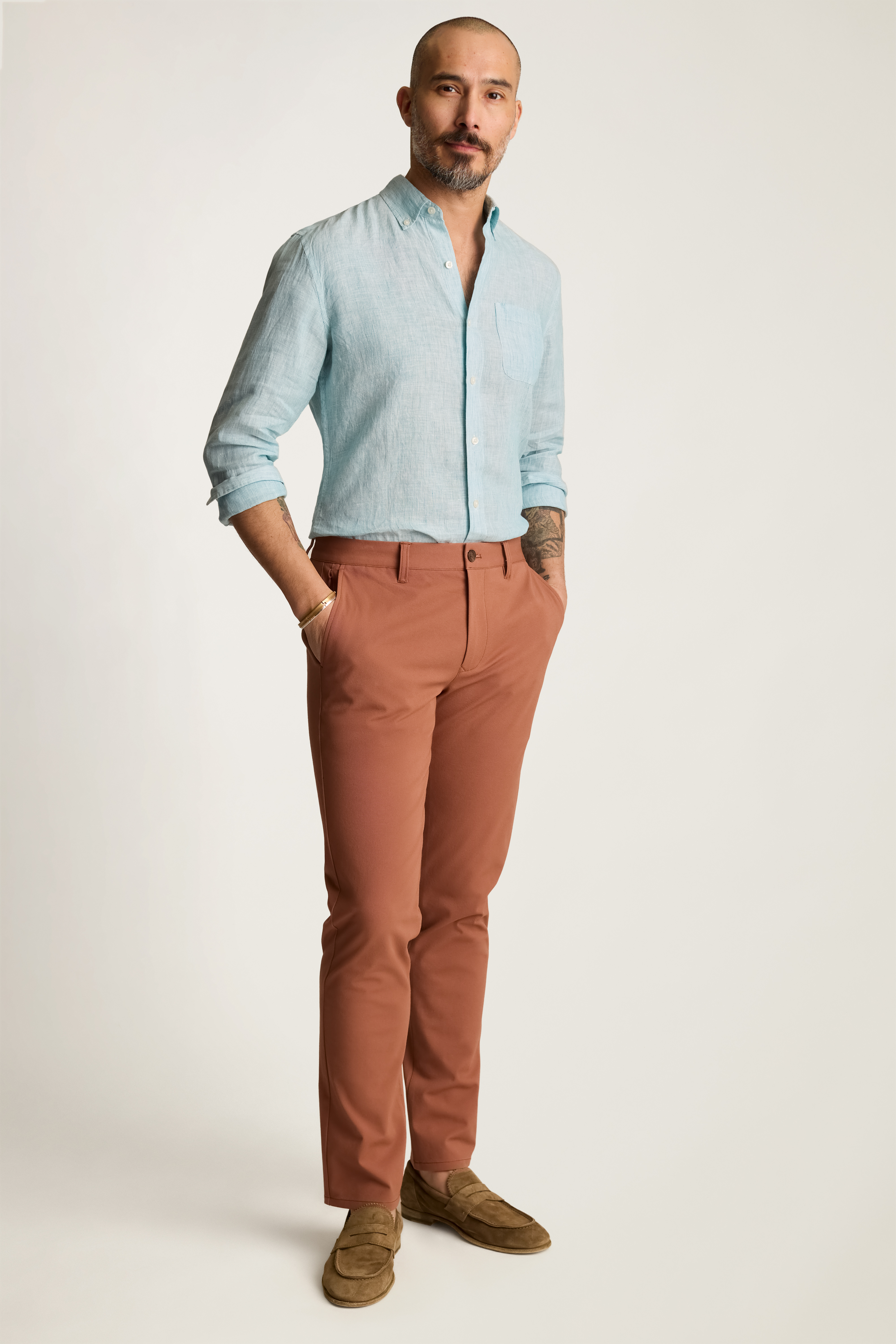 A man wearing orange chino pants